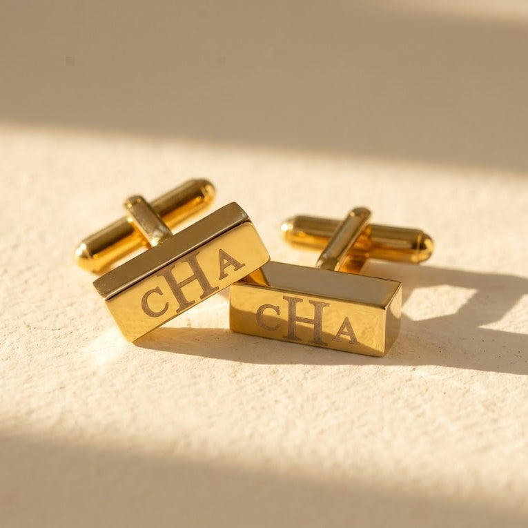 Personalized gold 3D bar cufflinks engraved with monogram initials in a modern rectangular design.
