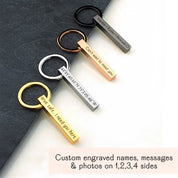 Collection of vertical bar keychains in black, silver, gold, and rose gold on a matte card, each etched with different phrases. Demonstrates color variety, deep engraving, and clean lines—ideal for monogram keyring, “drive safe I need you here” message, or matching groomsmen keychain set for weddings and bachelor party favors.