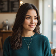 Custom engraved dainty 3D bar necklace shown on woman wearing a cozy sweater, minimalist vertical bar pendant on delicate chain, personalized with name or date, modern everyday jewelry in sterling silver or gold, thoughtful gift for her, birthday, anniversary or bridesmaids.