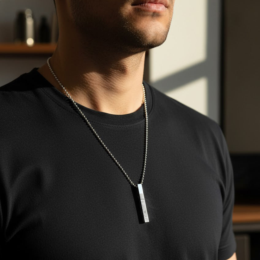 Men’s custom engraved 3D bar necklace in matte black stainless steel worn on a dark chain, featuring personalized four-sided engraving with coordinates, initials, dates or special message. Modern masculine necklace for boyfriend or husband, trending personalized men’s jewelry gift for anniversary, birthday or Father’s Day with durable minimalist bar pendant design.