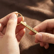 Close up of custom engraved stainless steel bar keychain personalized text engraving on metal keyring