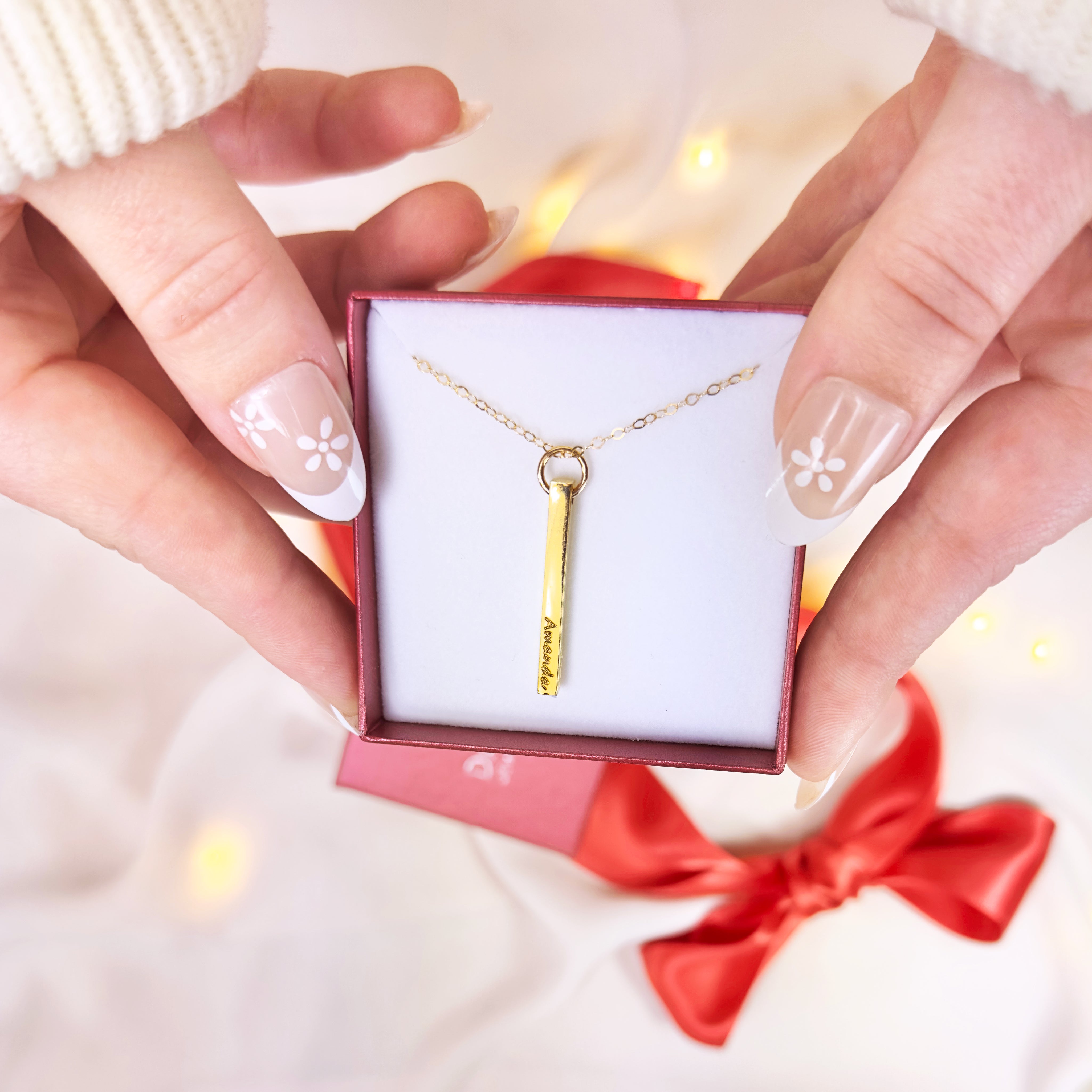 model holding gold plated dainty bar necklace engraved with name. necklaces for women, gift for her, gift for wife, birthday, christmas gift, valentine's day gift, gift for girlfriend, anniversary gift, silver anniversary, gold anniversary, personalized jewelry, custom jewelry, gift for fiance, holiday gift, unique gift ideas, necklaces for her, wedding party gifts, bridal party gifts, prom season, prom jewelry, birthstone necklaces, engraved necklaces, grad gift, graduation gift, present