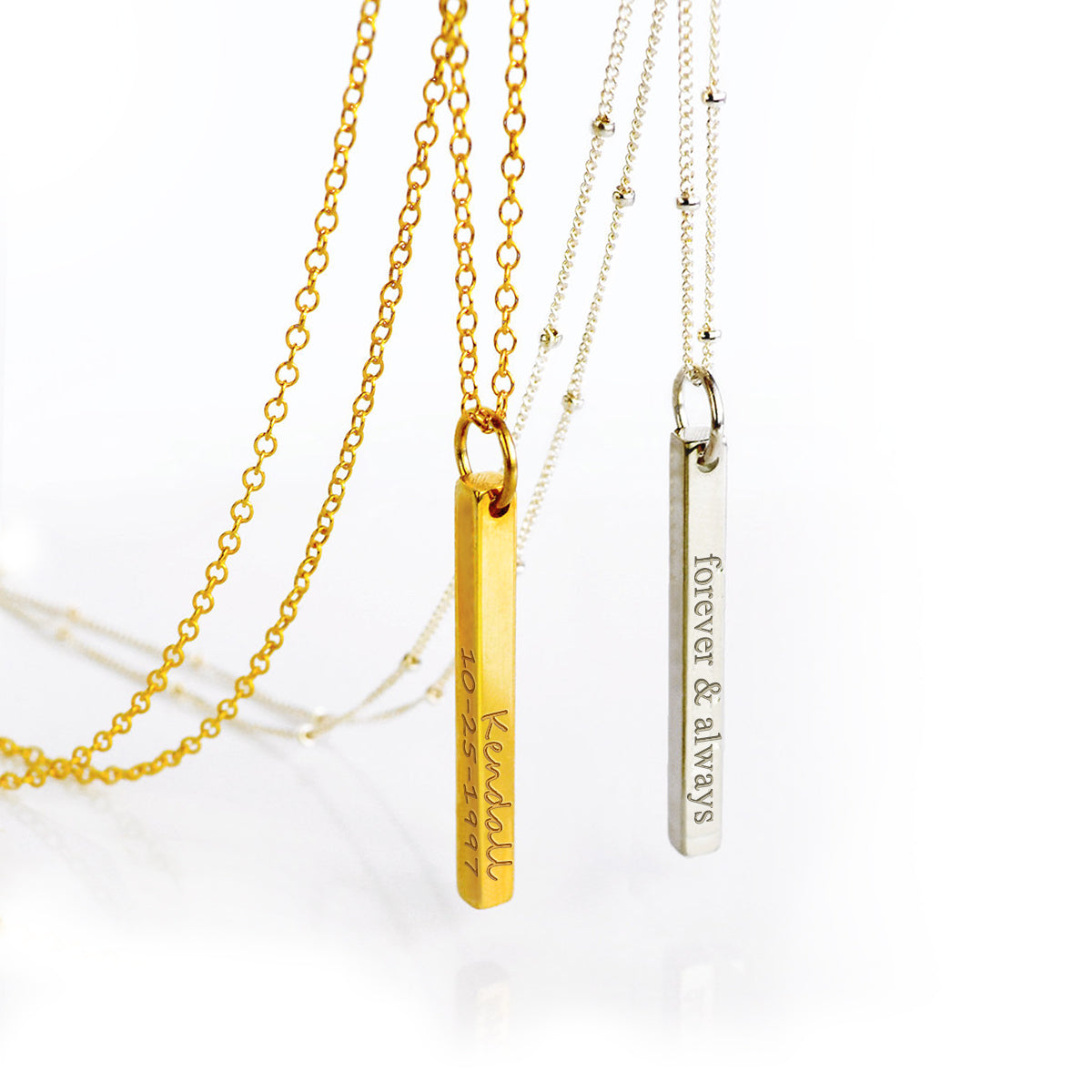 One gold filled dainty bar pendant on a cable chain with name and a special date engraved in our handscript writing. One silver dainty bar pendant on a satellite chain with a phrase and roman numerals engraved in our classic font style. necklaces for women, gift for her, gift for wife, birthday, christmas gift, valentine's day gift, gift for girlfriend, anniversary gift, silver anniversary, gold anniversary, personalized jewelry, custom jewelry, gift for fiance, holiday gift, unique gift ideas