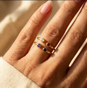 Stacked birthstone rings with natural gemstones on hand, minimalist layering jewelry for modern personalized styling