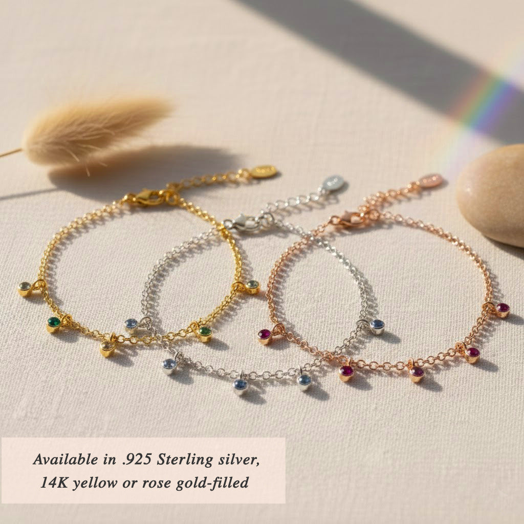 Birthstone dangle bracelets displayed together, available in sterling silver and gold finishes, custom family bracelet ideal for moms, grandmas, and meaningful gifting occasions