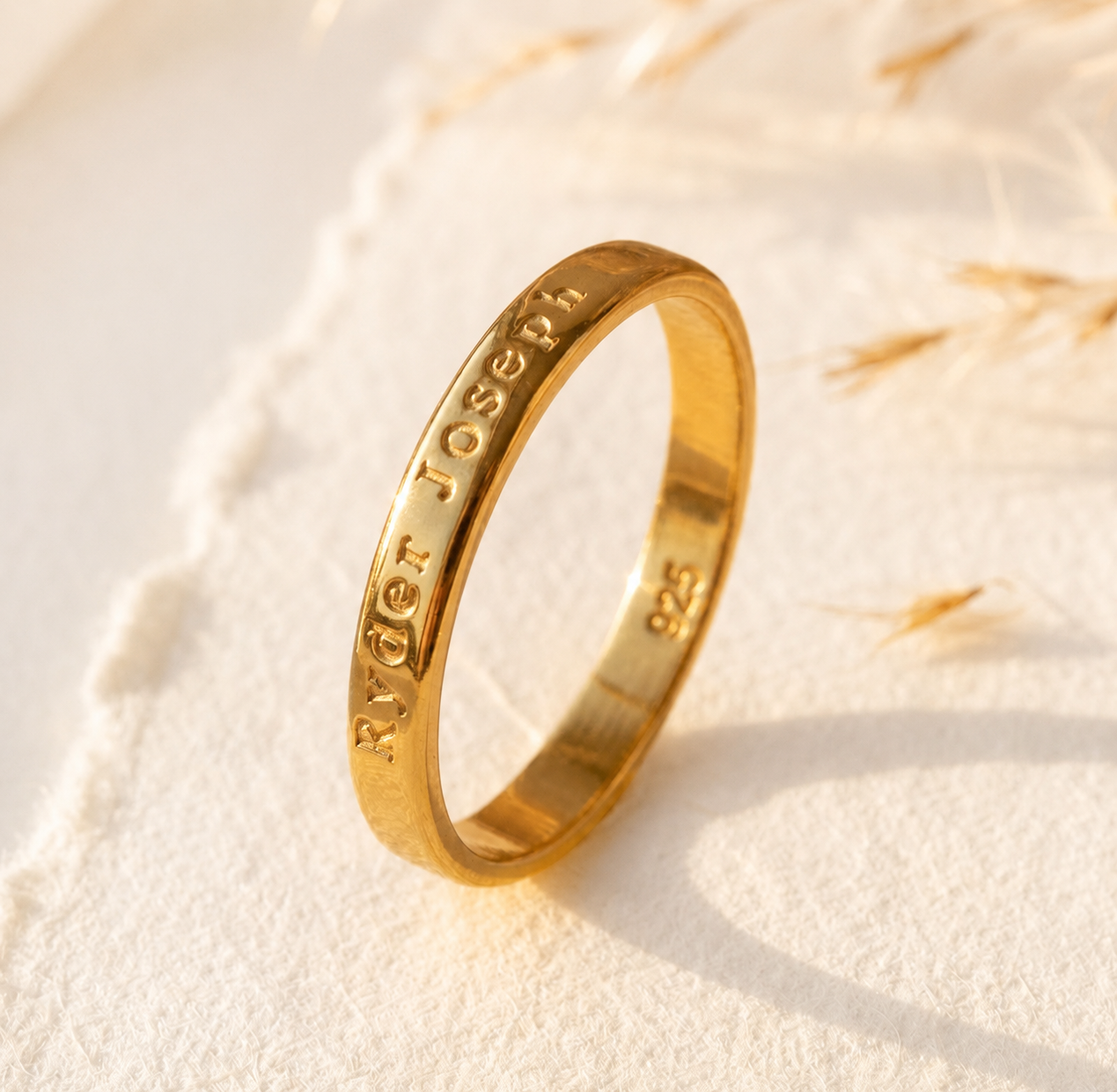 Personalized 3mm engraved ring in yellow gold vermeil with custom outside engraving on a soft neutral background.