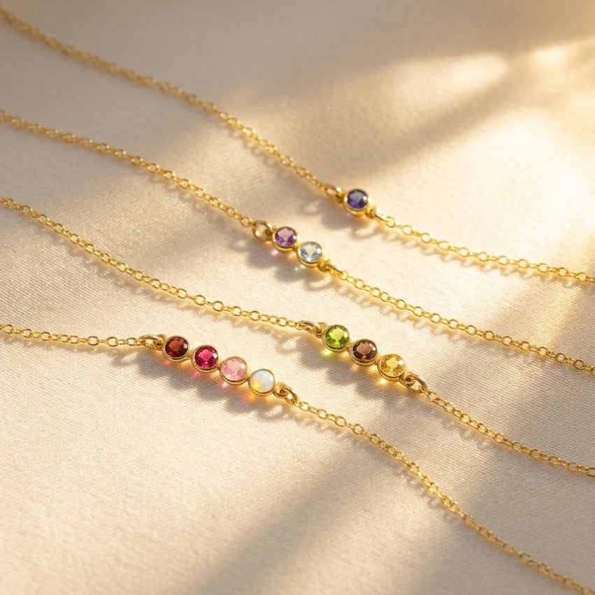 Horizontal minimalist birthstone bar necklaces in sterling silver and gold, featuring up to six gemstones representing family members or loved ones. This dainty bar pendant design is perfect for everyday layering or gifting as a meaningful Mother’s Day necklace, birthday present for mom, or anniversary keepsake. Customizable with personalized birthstones in all months, this elegant jewelry piece makes a timeless heirloom for women who love minimal and modern style.