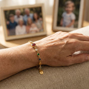Hand holding personalized birthstone bracelet for grandma with grandkids birthstones and initials, thoughtful Mother’s Day gift symbolizing motherhood and love
