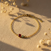 This custom mom birthstone bracelet features one larger 5mm stone for mother and up to six 3mm children birthstones on a delicate gold chain, creating a minimalist family keepsake jewelry piece perfect for Mother’s Day or a sentimental push present.