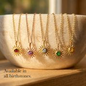 Custom birthstone sunburst necklaces shown in all birthstone colors on gold chains