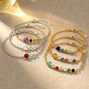 Celebrate family with this personalized birth month bracelet featuring one larger mother stone and smaller children stones, creating a modern minimalist design perfect for stacking or wearing alone.
