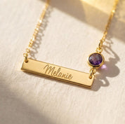 Personalized gold bar necklace engraved Melanie with purple birthstone connector