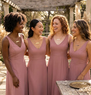Bridesmaids wearing coordinated personalized jewelry at outdoor wedding