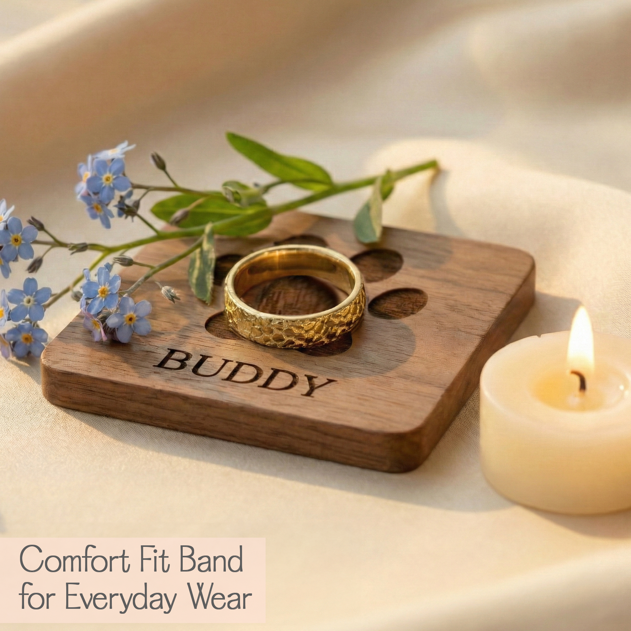 Lifestyle photo of a personalized pet nose print ring resting on a cozy tray scene with candle and florals, featuring a shiny comfort fit band engraved with your pet’s real nose texture from a submitted photo and optional inside text for name or date, a heartfelt pet memorial ring and remembrance jewelry for dog lovers, ideal as sympathy gift and rainbow bridge keepsake, timeless minimal design that layers well and is made for daily wear.