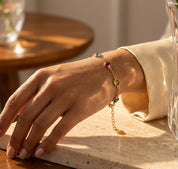 minimalist rose gold birthstone bracelet worn on hand, custom multistone jewelry inspired by Taylor Swift style