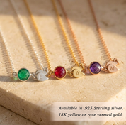 Gold birthstone necklace with initial charm representing children