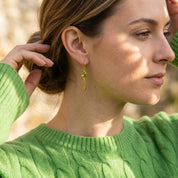 Model wearing green custom birthstone earrings with marquise tags, dainty personalized drop earrings
