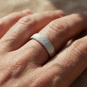 Dog nose texture engraved ring worn on finger, showcasing subtle pebble-style engraving inspired by a real dog’s nose, custom pet nose print ring in sterling silver, minimalist personalized pet jewelry, meaningful memorial dog ring, everyday wearable keepsake for pet owners