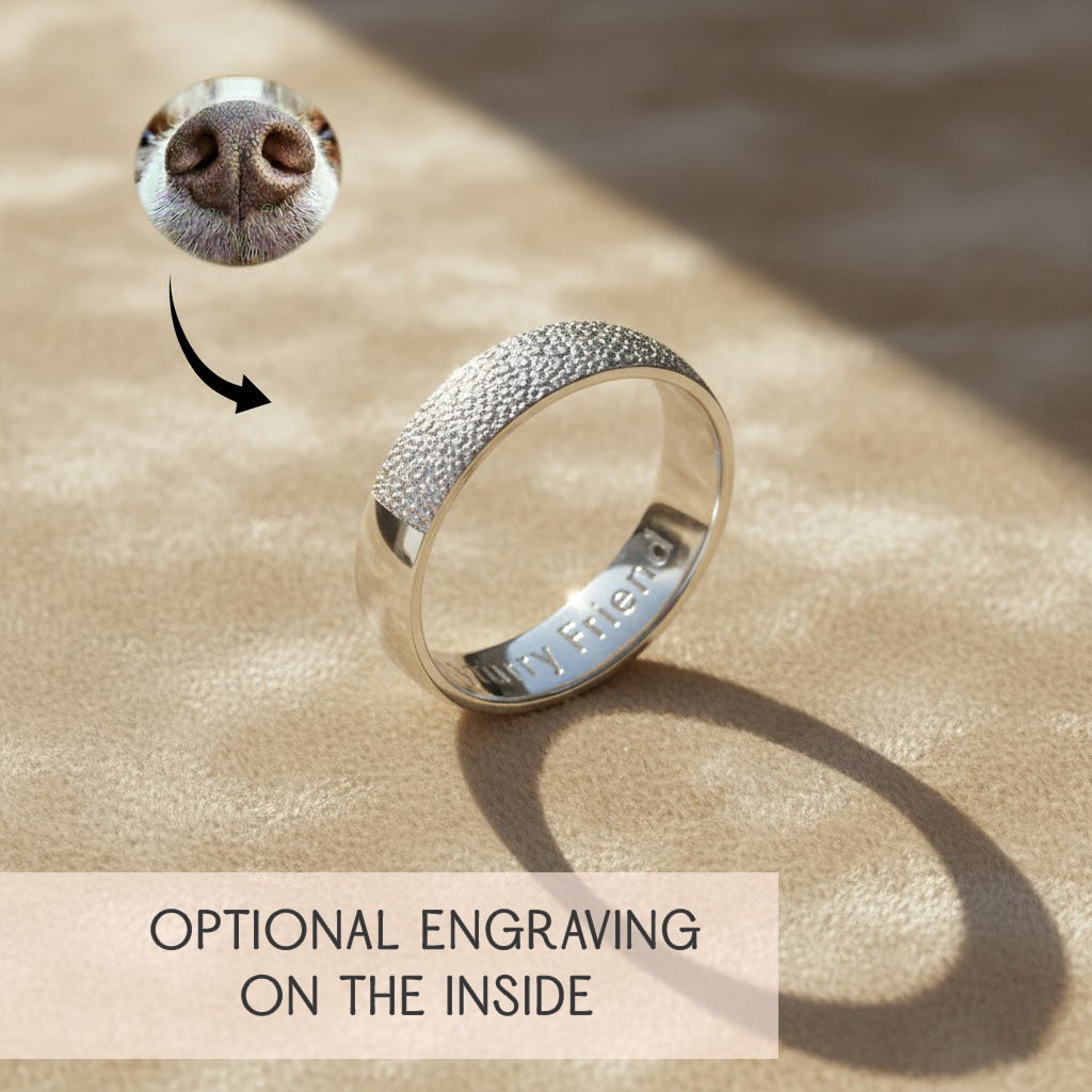 Custom sterling silver pet nose print ring on beige background, showing realistic dog nose texture wrapped around band with optional inside engraving, personalized memorial jewelry for dog or cat lovers, unique pet keepsake ring.