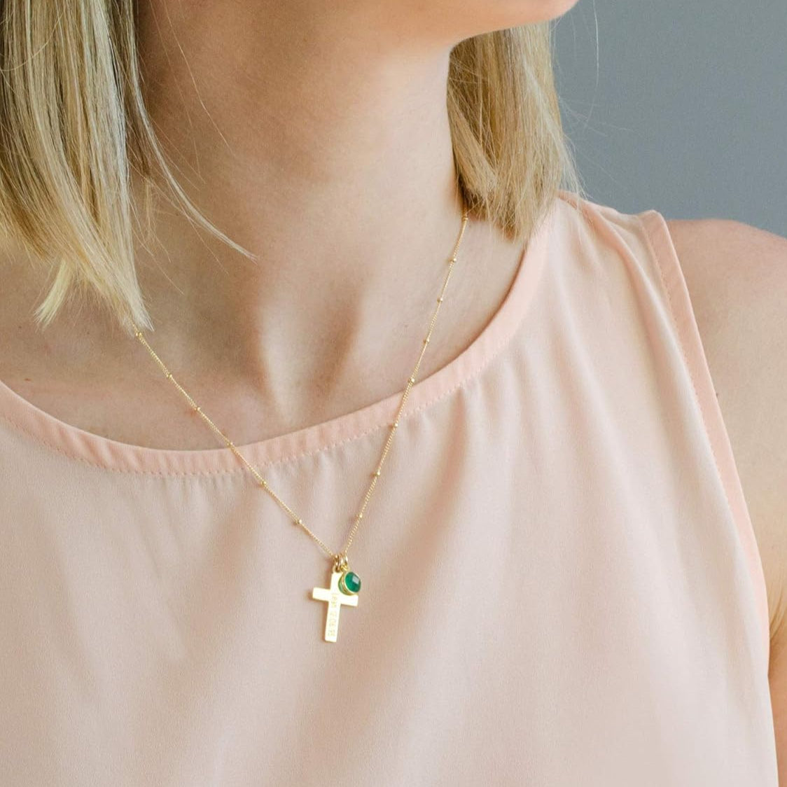 Model wearing gold cross necklace on satellite chain. Birthstone jewelry, first communion gift, easter gift, religious jewelry, cross jewelry, cross necklace, baptism gift, communion gift, gift or her, religious necklace, engraved cross charm, gift for mom, gift for teen, gift for girl, christmas gift, valentine's gift, birthday gift, anniversary gift. 