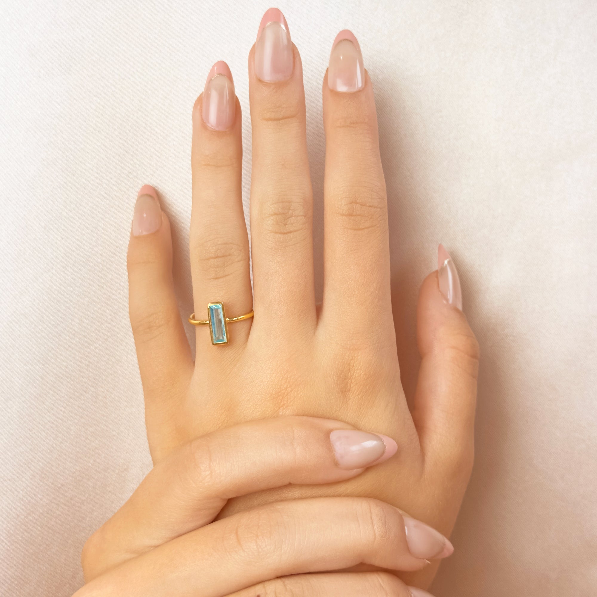 Blue-topaz-december-small-baguette-adira-ring-model.jpg