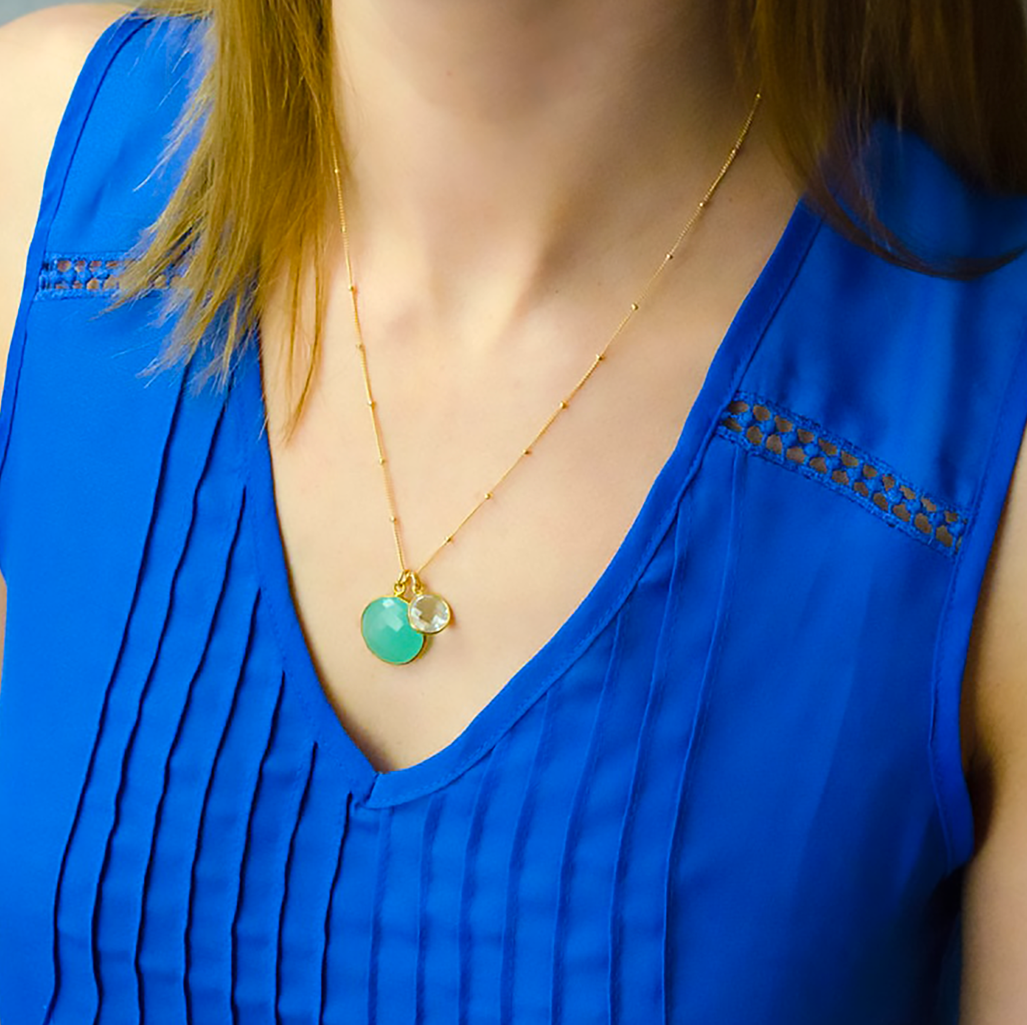 Lg_sm_round_18mm_10mm_birthstone_pendant_necklace_on_person.png