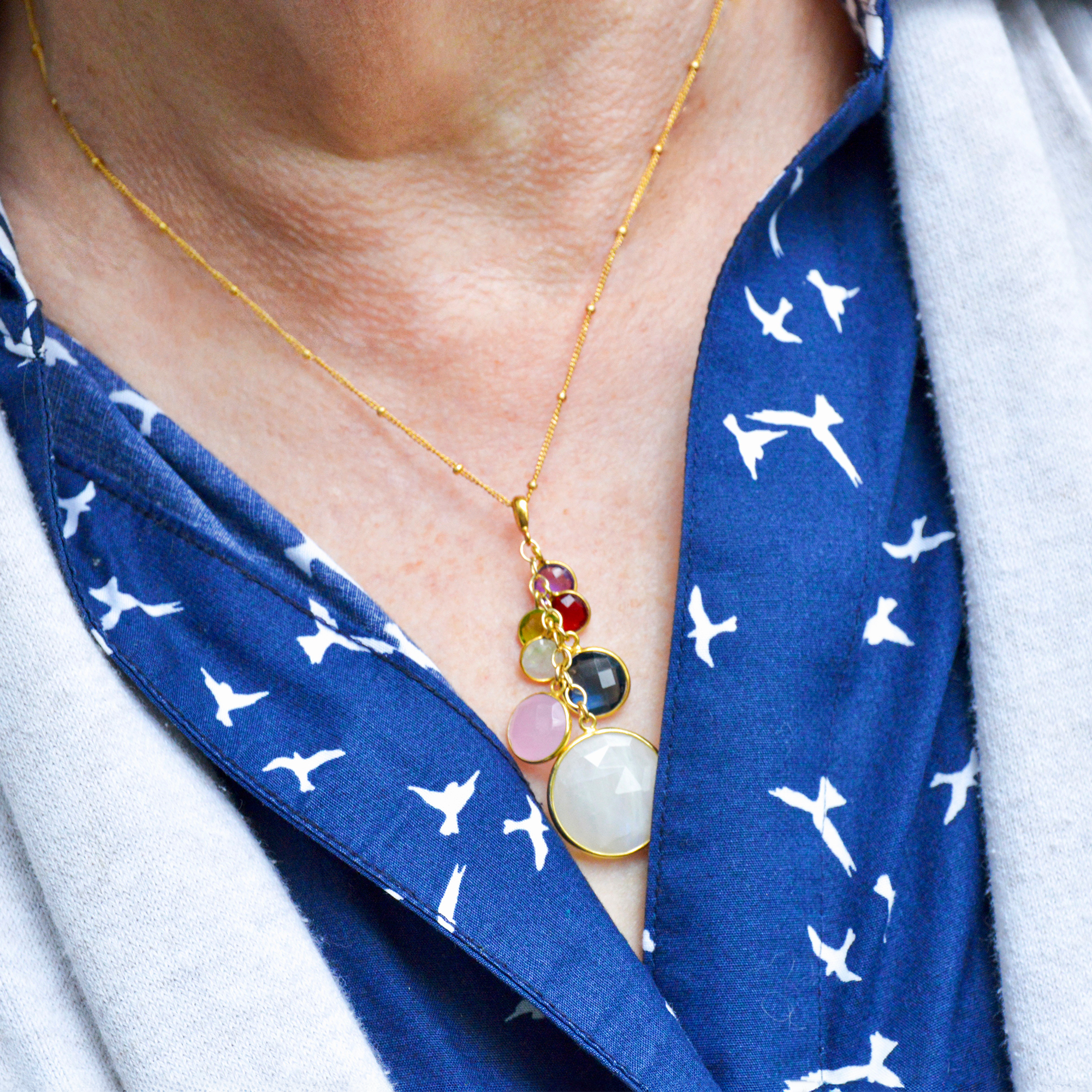 Gift for Grandma Family Necklace With Kids and3 cascade birthstone necklaces in gold, silver and oxidized silver lay in a swirling pattern on a white background. Grandkids Birthstones Gold or Silver, October birthstone necklace for grandma, December birthstone necklace for grandma, April birthstone necklace for grandma, personalized birthstone jewelry for grandmother