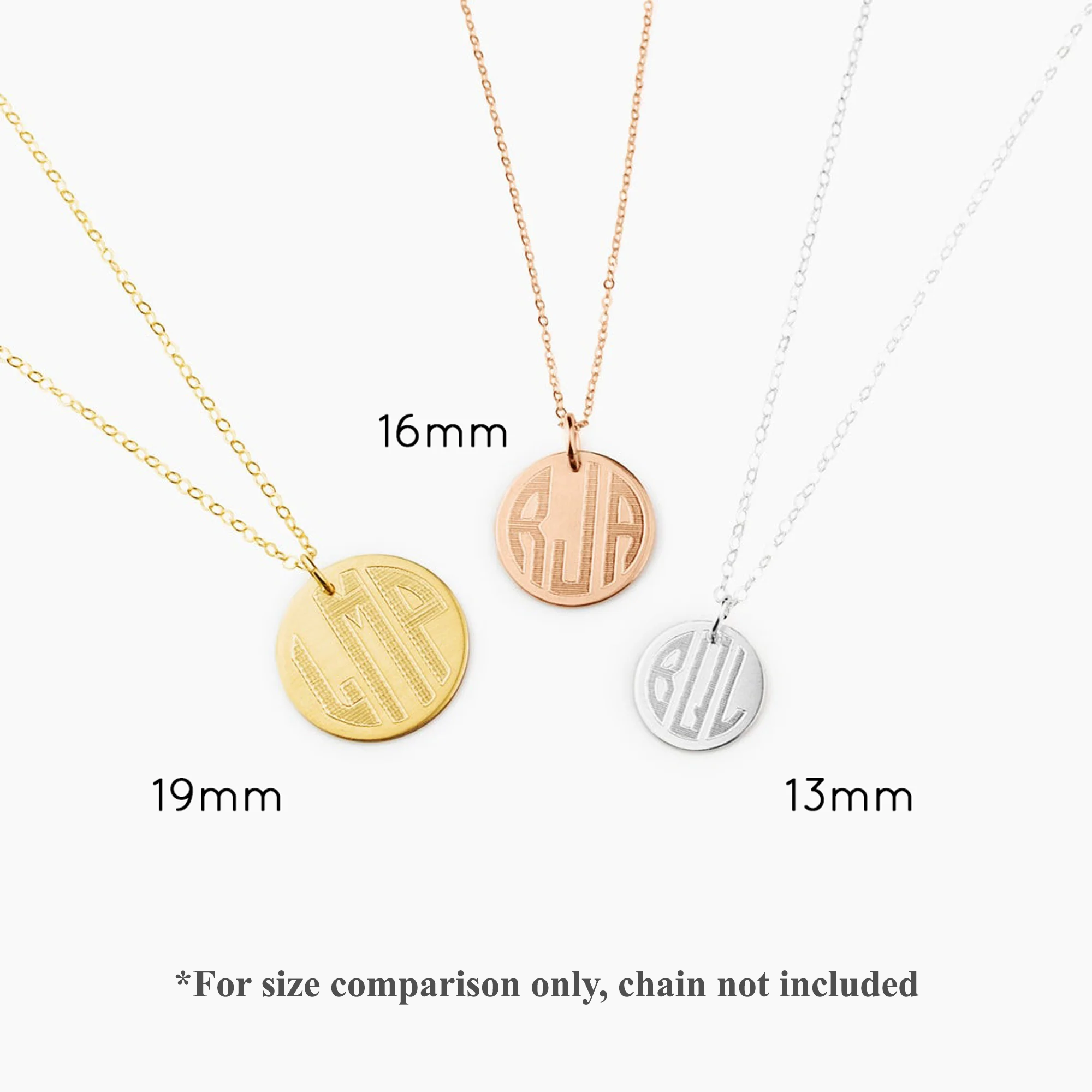 Three engraved monogram disc pendant necklaces.