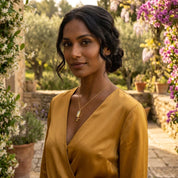 Gold baguette birthstone necklace for mom with tiny kids’ birthstone charms, designed as a sentimental personalized necklace for Mother’s Day, birthdays, or new moms.