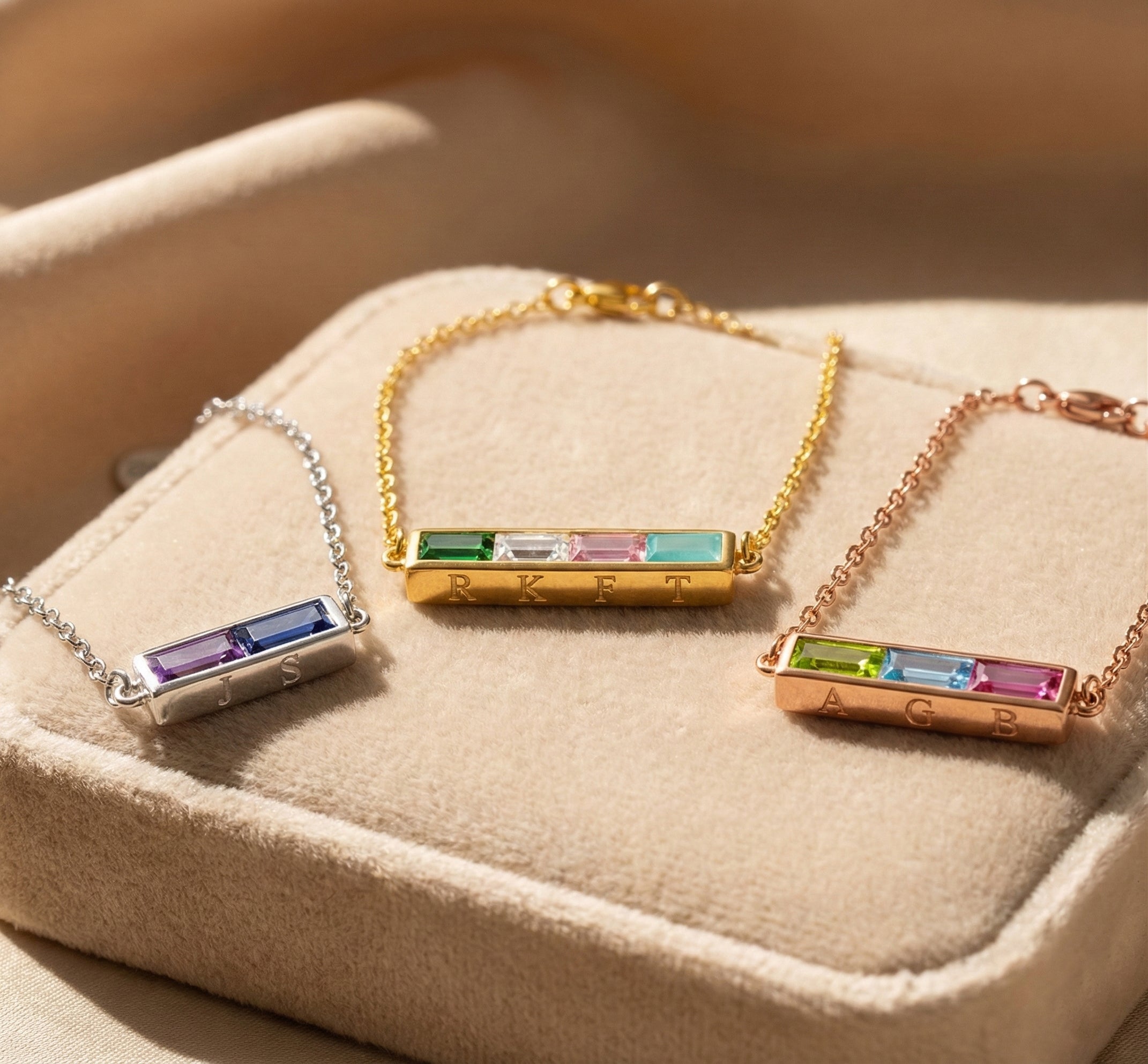 Personalized birthstone bar bracelets displayed together, custom engraved hidden initials bracelet in sterling silver yellow gold and rose gold, rectangular birthstone bracelet for women, minimalist layered jewelry, custom family bracelet, dainty engraved bracelet gift for mom, sister, bridesmaid, best friend, or birthday present with colorful birth month stones