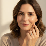 Portrait of woman wearing adjustable double birthstone ring, dainty personalized family ring with open band design in yellow gold