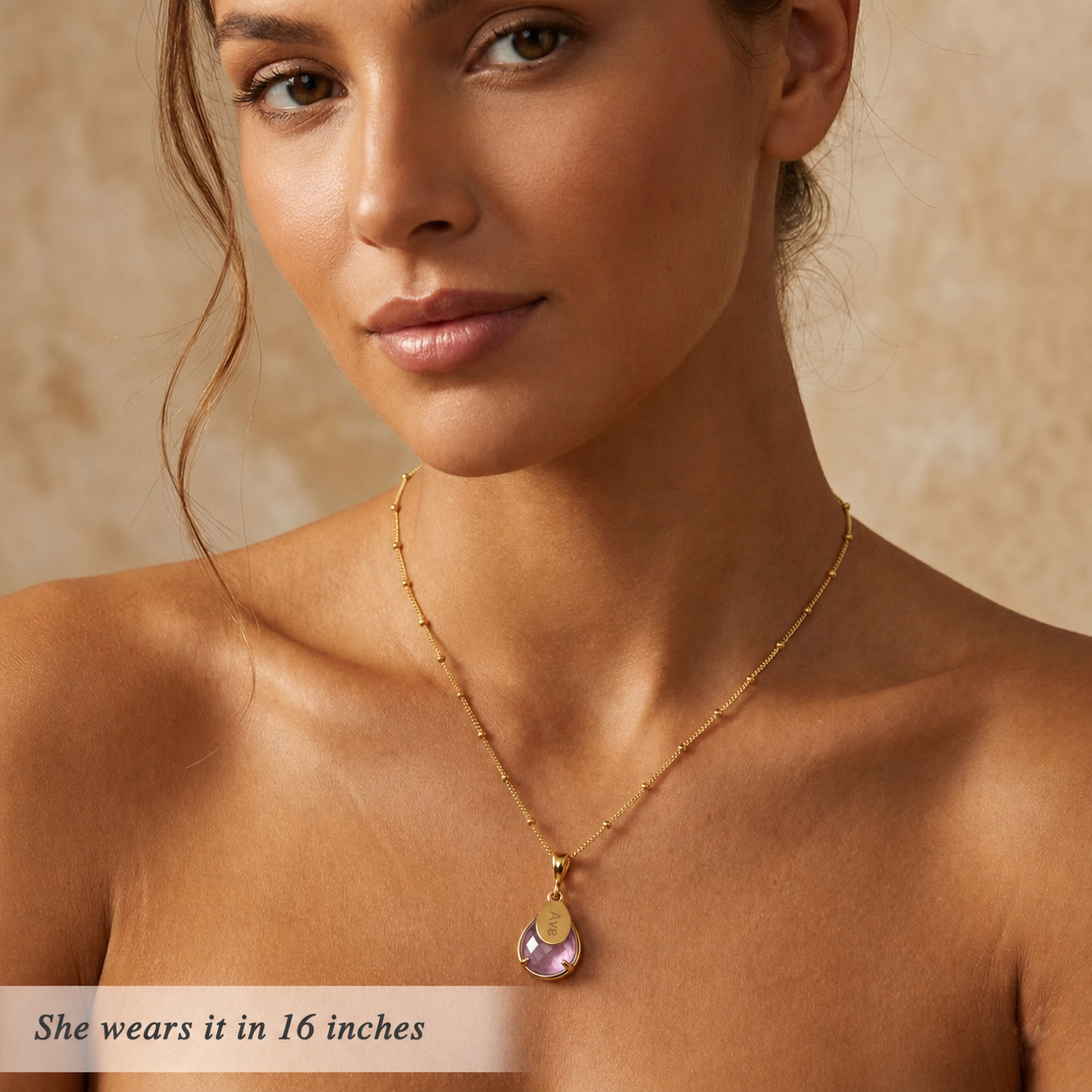 Model wearing a 16 inch personalized alexandrite necklace with engraved oval name tag and gold filled chain
