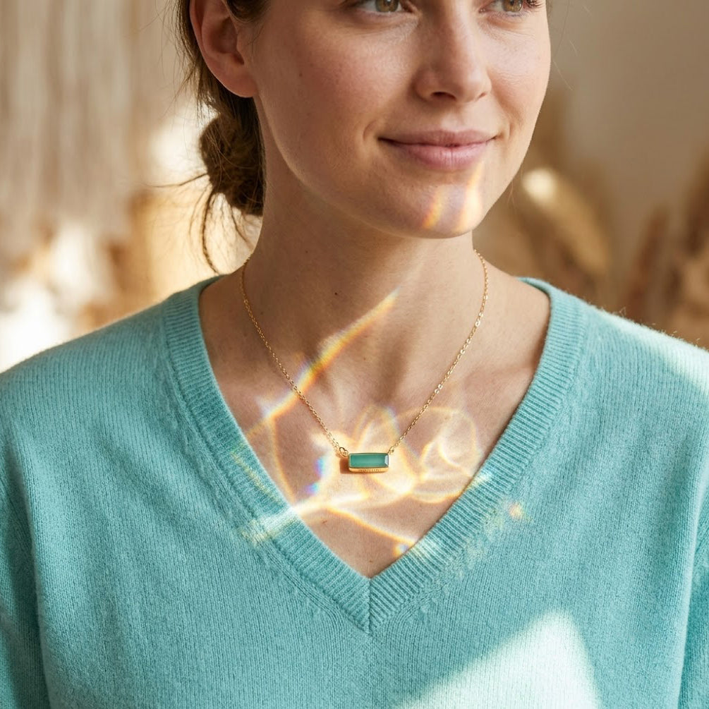 Model wearing a dainty aqua chalcedony baguette bar necklace with a delicate gold chain.