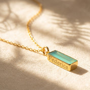 Aqua chalcedony bar necklace with hidden engraved name, personalized March birthstone necklace on a delicate gold chain.