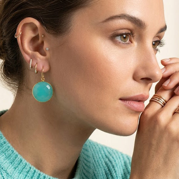 Model wearing aqua chalcedony earrings in gold, dainty March birthstone dangle earrings for everyday wear