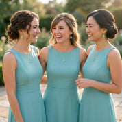 Bridesmaids wearing aqua chalcedony necklaces matching blue gemstone jewelry for wedding bridal party