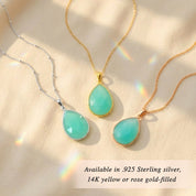 Model wearing aqua chalcedony necklace in gold soft blue green gemstone March birthstone pendant