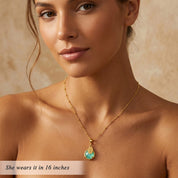 Woman wearing aqua chalcedony necklace with engraved name charm, dainty March birthstone jewelry in gold