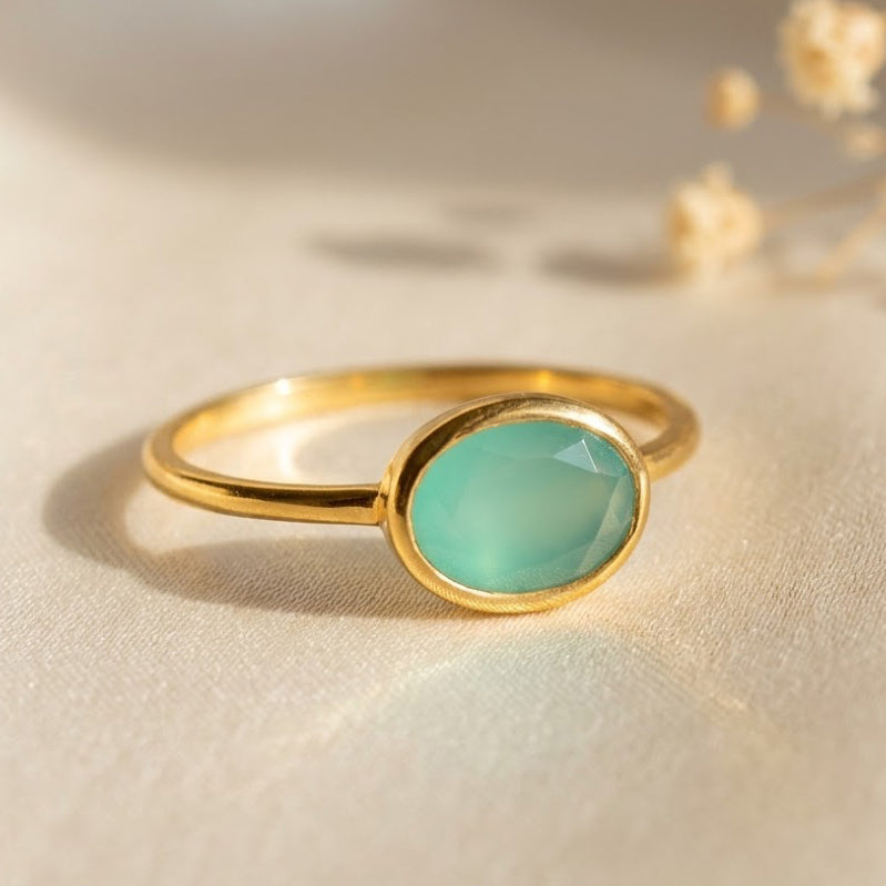 a gold aqua chalcedony ring shown on white background. Stacking rings, bezel set, small oval, tiny oval, dainty oval, birthstone rings, sterling silver stamp, birthstone ring, birthstone jewelry, march birthstone, march gemstone, stack set, stacking rings, gemstone ring, birthstone ring, mother's day gift for her, gift for mom, gift for fiance, gift for girlfriend, wedding jewelry, bridesmaid jewelry, anniversary jewelry, anniversary gift, birthday gift, christmas gift, valentine's day gift