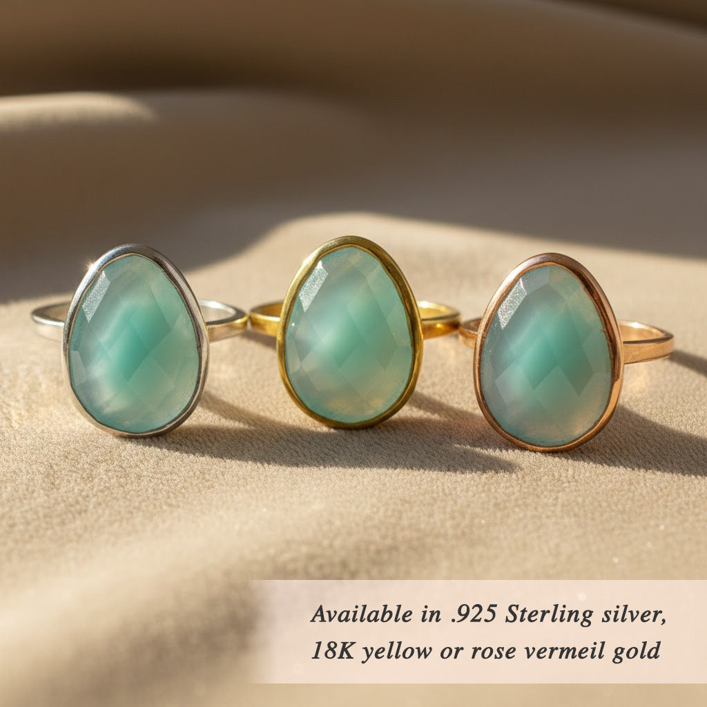 Aqua Chalcedony gemstone ring in a bezel setting on model's hand, available in sterling silver or gold options