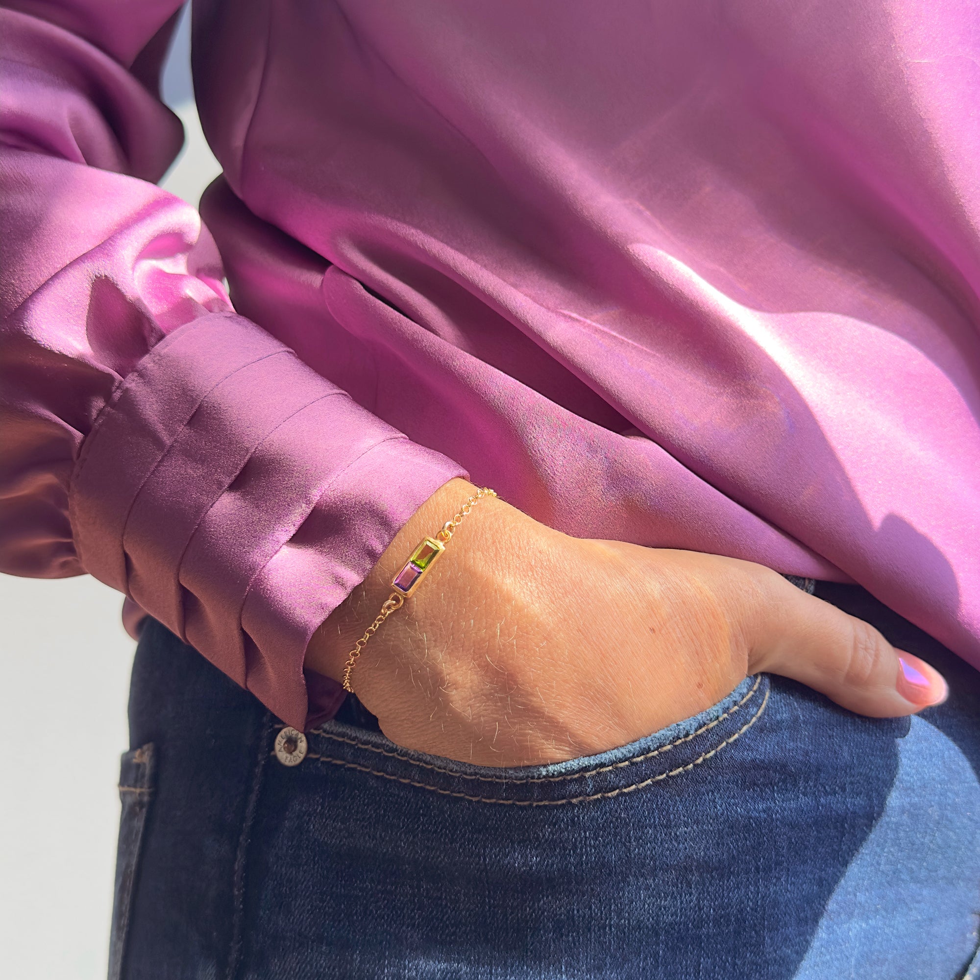 Woman wearing gold multiple baguette birthstone bracelet with customizable stones, a perfect personalized gift for mom or grandma.