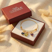 Custom charm bangle for mom with kids names and birthstones in danique jewelry branded box