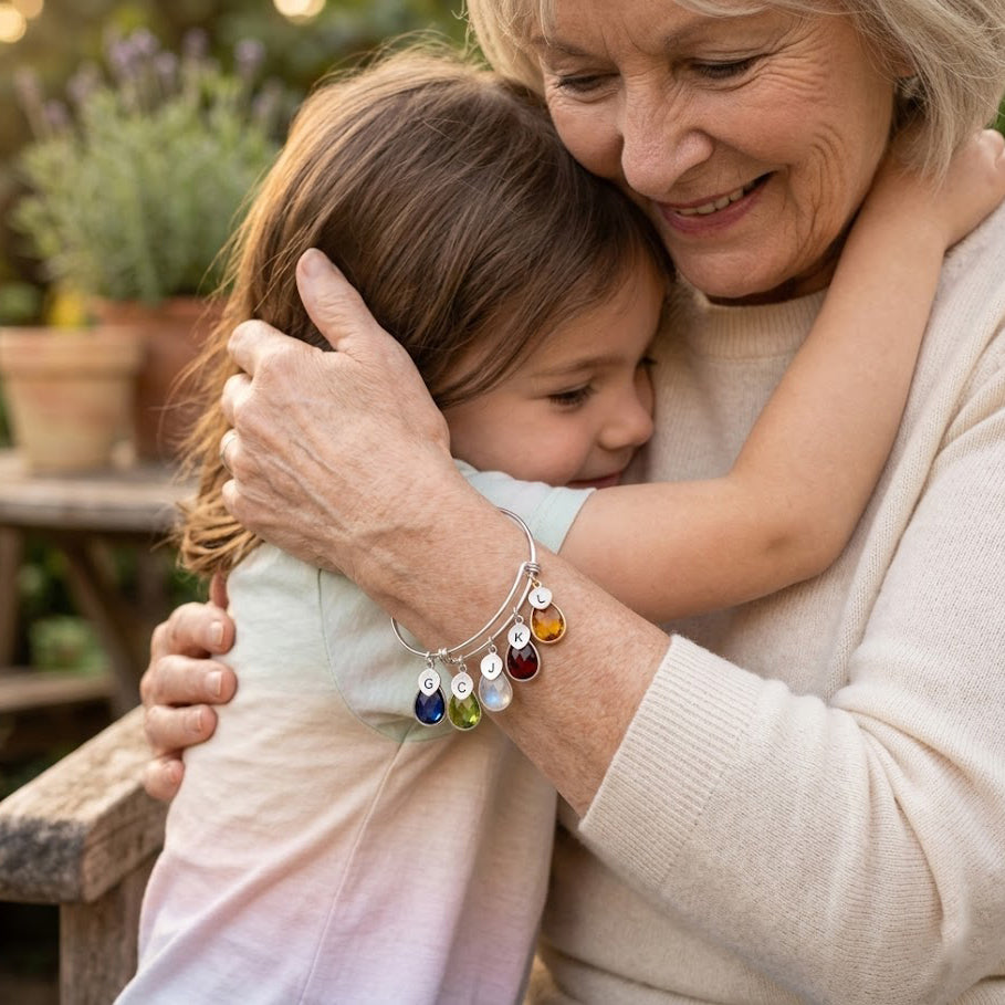 Woman wearing birthstone charm bangle with initials custom mom bracelet with colorful gemstone drops