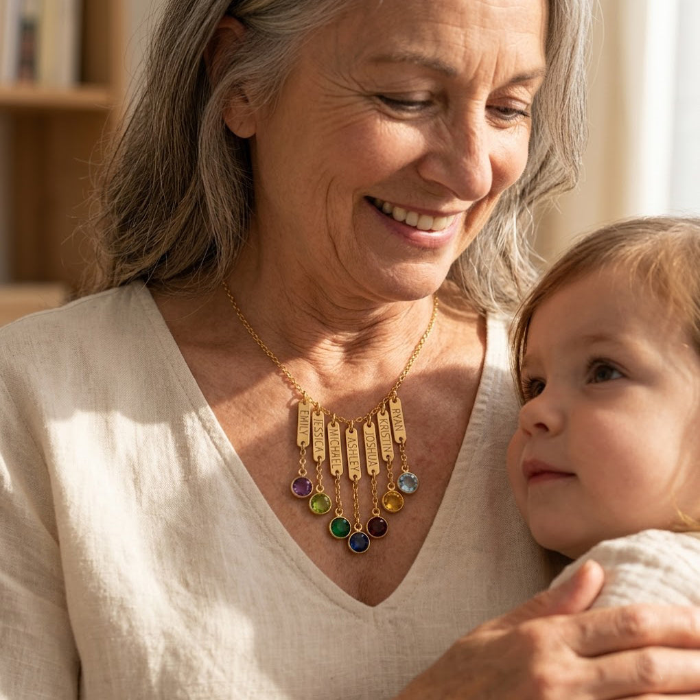 Grandmother wearing engraved name and birthstone necklace with grandchild, personalized grandma necklace with custom birthstone charms.