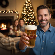 Personalized beer glass holiday gift, custom engraved pint glass for dad or husband, etched barware Christmas gift idea for beer lovers, festive family celebration scene.