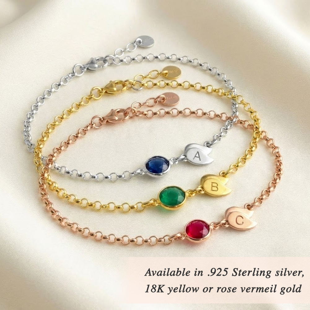 Stacked custom birthstone bracelets in sterling silver, yellow gold, and rose gold with engraved initial charms, personalized family jewelry gift for women