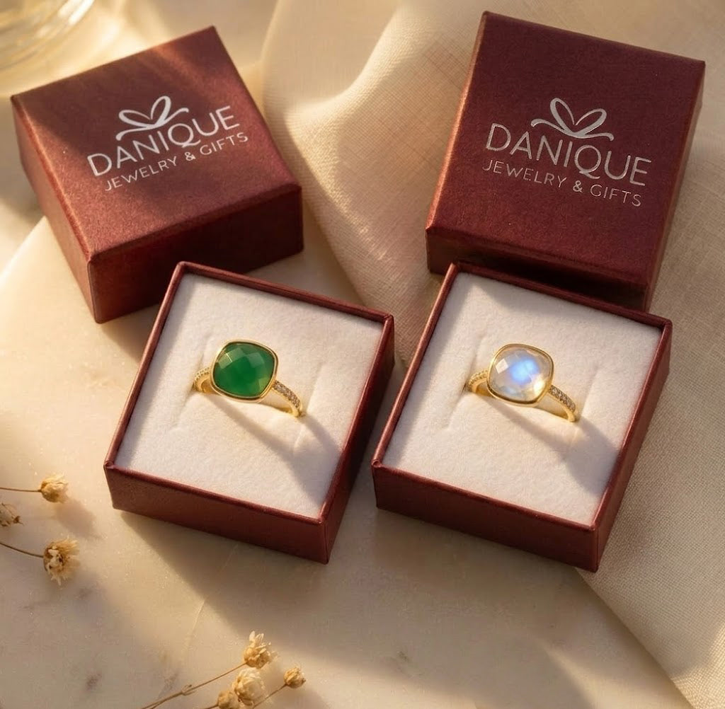 Green onyx ring presented in a burgundy Danique Jewelry gift box beside another gemstone ring.