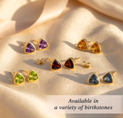 Triangle birthstone stud earrings shown in a variety of gemstone colors available for each birth month.