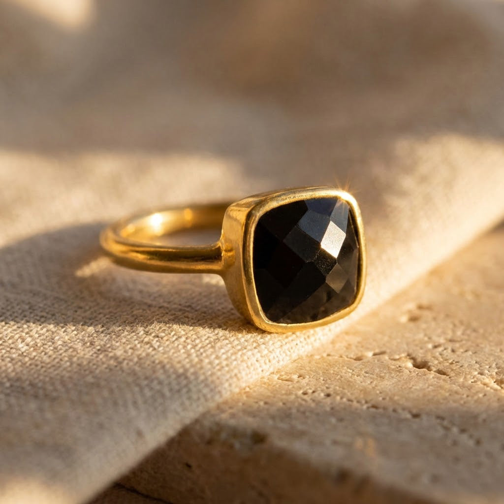 Black onyx cushion ring in gold bezel setting featuring a faceted square gemstone, modern minimalist statement ring for women available in sterling silver, yellow gold vermeil and rose gold vermeil, elegant everyday luxury jewelry