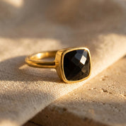 Black onyx cushion ring in gold bezel setting featuring a faceted square gemstone, modern minimalist statement ring for women available in sterling silver, yellow gold vermeil and rose gold vermeil, elegant everyday luxury jewelry